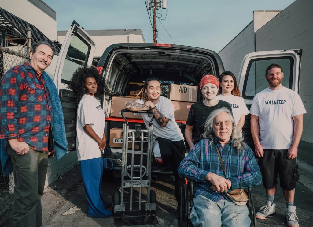 pexels-photo-6646779-6646779 A diverse group of volunteers packing aid supplies into a van for donation.